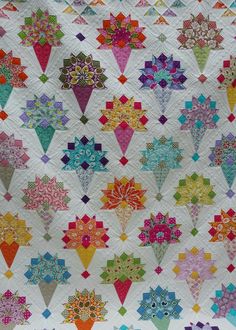 a colorful quilt with many different designs on it