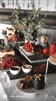 an assortment of food is displayed on a table in front of a window with the words send message above it