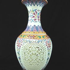 a white vase with colorful designs on it