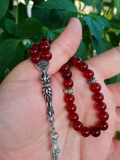 ✔️ This magnificent tasbih made with AA quality 8 mm carnelian agate beads. ✔️ It is a elegant and striking tesbih. ✔️ Natural Color ✔️ Natural Stone ✔️ Each order comes in a special box. ✔️ PLEASE CLICK THE LINK FOR ALL PRAYER BEADS MODELS https://www.etsy.com/shop/GoodJewelsofYazmasal Note: As a natural feature the stones beads may have some variations. SHIPPING: United States (Standart/DHL eCommerce/usps): 7-10 business days United States (Express/FedEx): 3-5 business days Canada (Express/Fed Red Gemstone Beads As Gift, Traditional Carnelian Beads As A Gift, Red Spiritual Beads As Gift, Red Spiritual Beads And Cabochons For Jewelry Making, Red Carnelian Beads For Gift, Round Beads Rosary With Natural Stones For Gift, Bohemian Red Beads And Gems For Gifts, Red Gemstone Beads For Gifts, Red Carnelian Beads For Gifts