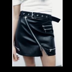 High-Waist Mini Skirt With A Belt In The Same Fabric With Metal Buckle, Zip Appliqus. Black Skirt With Belt Loops For Fall, Fall Skirt With Belt For Night Out, Spring Night Out Skirt With Belt Loops, Spring Skirt With Belt Loops For Night Out, Edgy High-waist Skirt With Belt Loops, Edgy Skirt With Belt Loops For Fall, Casual Black Mini Skirt With Belt, Trendy Skirt With Belt Loops For Night Out, Trendy Night Out Skirt With Belt Loops