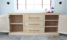 a wooden cabinet with drawers and shelves in the corner