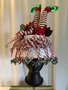 Over the top vintage bucket hat relished into the perfect accessory to your ugly Christmas sweater! Vintage har sprayed white, decorated with plastic candy canes, two artificial poinsettias, red, white and green wired bow, tow upside down elf legs, metallic holiday rings the edge with lights (AA batteries required). One of a kind creation from Red Button Art Studio, aveteran in Iowa, signed with a red button. Vintage Bucket Hat, Elf Legs, Vintage Bucket, Vintage Hat, Button Art, Red Button, Sweater Vintage, Top Vintage, Christmas Hat