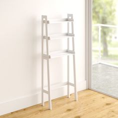 a white shelf sitting on top of a wooden floor next to a sliding glass door