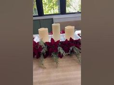 the table is set with candles and flowers on it, along with other holiday decorations