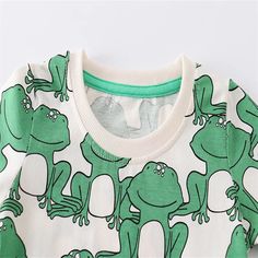 Make a splash with these adorable 2-7T Boys Suits! These tees and shorts sets feature fun animal prints, like a cute frog, for your little one to wear while they play. Perfect for hot summer days, these outfits will keep your baby cool and stylish. Material: Cotton Green Tops With Character Print For Spring, Green Dinosaur Print Top For Spring, Green Dinosaur Print Tops For Spring, Casual Dinosaur Print Tops For Playwear, Casual Tops With Dinosaur Print For Playwear, Funny Print Tops For Summer Playtime, Funny Print Tops For Spring Playtime, Cute Dinosaur Print Tops For Spring, Dinosaur Print Short Sleeve Tops For Spring