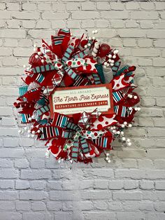 a red, white and blue wreath on a brick wall that says the happy place to be