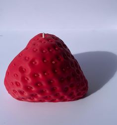 a strawberry shaped like a heart on a white surface