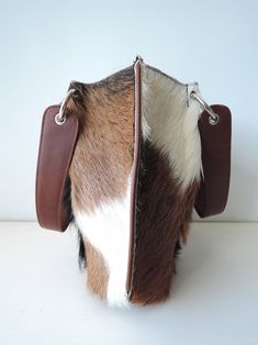 "BROWN WHITE COWHIDE Fur Purse, Crossbody Bag Women, Purse Tote Bag, Hair On Hide Purses, Ready To Ship Bag, Amazing Gift For Her DARK BROWN COWHIDE Leather Bag, Luxury Bag, 1 of a kind super soft and divine to the touch. Silky smooth hide hair tote bag perfect for every occasion; work, lunches with friends to romantic weekends and evening strolls. Size Inches : Length 15\" X Heigh 10.2\" X Wide 3.8\" Size Cm : Length 38 cm X Heigh 26 cm X Wide 9.5 cm Not too big, not too small! It's just right! White Leather Bucket Bag With Phone Pocket, White Leather Bucket Bag With Phone Holder, White Leather Bucket Bag With Phone Slot, White Leather-handled Pouch Satchel, White Handheld Shoulder Bag With Leather Handles, Hair Bag, Cowhide Purse, Fur Purse, Cowhide Bag