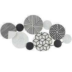 several black and white circles are arranged on the wall, with one circle in the middle