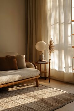 a living room with a couch, lamp and window