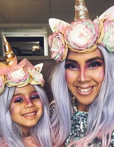 two women with unicorn makeup and hair are smiling