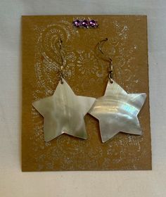 "These White Mother of Pearl Star Shaped Earrings will be the star of your earring show! They are lightweight and comfortable to wear as they dangle from your earlobes and light up your beautiful, happy face. Shiny & irridescent, these shell star earrings will make any outfit feel special.  Measures 1 3/4\" star tip to star tip. Silver Earwires" Celestial Stars, White Star, Earrings White, Shell Earrings, Feel Special, Happy Face, Feeling Special, Star Earrings, Star Shape