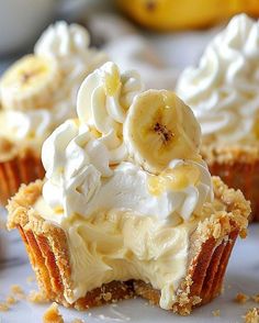 banana cream cupcakes on a white plate with bananas in the backgroung