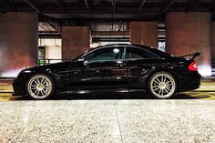 a black car parked in an empty parking garage