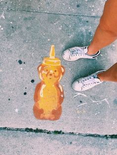 a person standing next to a yellow fire hydrant with a dog painted on it