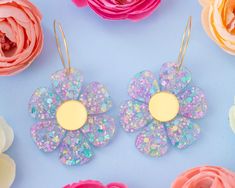 These light-weight daisy earrings are the perfect statement earrings to add an extra pop to your outfit! Acrylic is very lightweight so you can enjoy large, statement earrings comfortably all day. ♡ Made with multi-coloured confetti acrylic ♡ Size: Approximately 2.5 inches in length measured from top of earring hoop ♡ Earring hoop is made from 18k gold plated brass ♡ Care Instructions: ♡ - To clean: Wipe with a microfiber cloth to remove any dust - Avoid contact with perfumes and lotions as thes Trendy Flower Charm Earrings For Spring, Trendy Summer Flower Charm Earrings, Trendy 3d Flower Earrings For Spring, Trendy Hoop Earrings With Flower Charm For Spring, Trendy Flower Hoop Earrings For Summer, Handmade Flower-shaped Hoop Earrings For Spring, Daisy Flower Earrings For Spring, Flower Shaped Hoop Earrings For Summer, Trendy Spring Flower Earrings For Gift