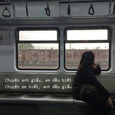 a woman sitting on a train looking out the window