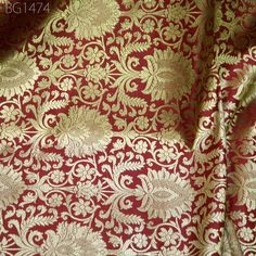 Maroon Gold Indian Banarasi Fabric Wedding Dress Banaras Fabric by the Yard Crafting sewing Costumes Lehenga Skirt jacket home decor brocade. This is a beautiful heavy benarse blended silk brocade floral design fabric in Maroon and Gold.  ➤Product: Brocade Fabric ➤Fabric Type: Blended Silk (Viscose and Silk) Fine quality Zari Brocade Weaving from Banaras ➤Color: Maroon and Gold ➤Width: 44 inches. ➤Condition: New  ➤Code: bg1474 ➤Listing for 1 Yard of fabric. ➤Care: Dry Clean Only This is known as "Kimkhab". During the Mughal period (1556-1707), when kimkhwāb was extremely popular with the rich, the great centres of brocade weaving were Benares (Vārānasi). You can use this fabric to make Dresses, Tops, Blouses, Jackets, Crafting, Clutches or Evening Bags, Embellish your clothes, Pillows, Dra Wedding Sets In Brocade With Traditional Patterns, Elegant Sherwani With Zari Weaving For Wedding, Brocade Blouse Piece With Traditional Drape, Elegant Brocade Blouse Piece With Motifs, Festive Brocade Blouse Piece For Traditional Ceremonies, Unstitched Brocade Blouse Piece For Wedding, Brocade Blouse Piece For Eid Wedding, Bollywood Style Brocade Kurta For Puja, Eid Wedding Brocade Blouse Piece