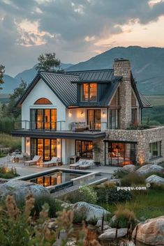 a large white house sitting on top of a lush green hillside