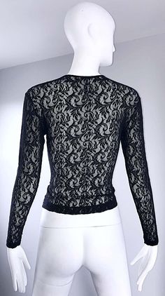 For Sale on 1stDibs - Sexy vintage 90s CALVIN KLEIN black lace cropped top shirt ! Features a fine soft lace that stretches to fit. Tailored body, with sleek long sleeves. Looks Black Lace Tops For Party, Black Lace Party Tops, Elegant Cropped Top With Delicate Lace, Evening Stretch Lace Top, Fitted Long Sleeve Lace Top With Delicate Lace, Elegant Sheer Cropped Top, Fitted Delicate Lace Top For Night Out, Black Fitted Tops With Lace Sleeves, Fitted Black Tops With Lace Sleeves