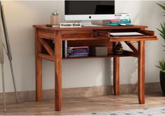 a wooden desk with a computer on it