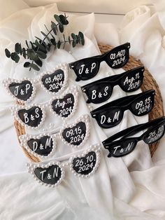 six heart shaped sunglasses with names and date written on them