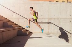 a man is running down some steps in the sun with his feet up and one hand on his hip