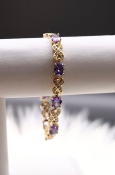 The Purple Gemstones Infinity Bracelet gracefully intertwines the symbolism of infinity with the allure of rich purple gemstones, creating a captivating and meaningful accessory. This bracelet adds a touch of royal elegance to your ensemble while conveying a sense of eternal beauty. Amethyst Bracelet Gemstones, Elegant Purple Gemstone Bracelets, Elegant Amethyst Gemstone Bracelets, Purple Cubic Zirconia Bracelets As Gift, Purple Cubic Zirconia Bracelets For Gift, Purple Cubic Zirconia Bracelet As Gift, Elegant Amethyst Bracelets For Anniversary, Elegant Purple Cubic Zirconia Bracelets, Elegant Amethyst Bracelet For Anniversary