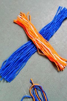 an orange and blue string laying on the ground