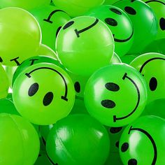 many green balloons with faces drawn on them