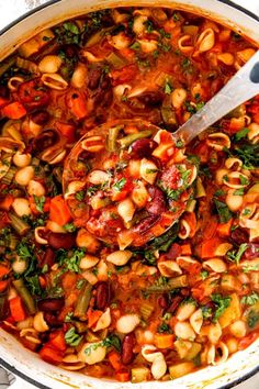 a large pot filled with pasta and vegetables