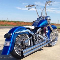 a blue motorcycle parked on top of a parking lot