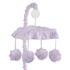 a purple baby crib mobile with flowers hanging from it's sides and a button on the top