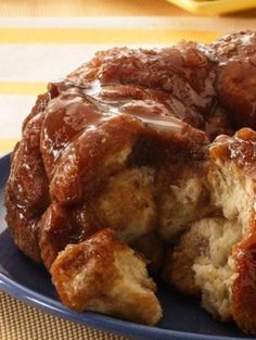 a bundt cake is on a blue plate with caramel sauce drizzled over it