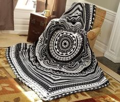 a black and white blanket sitting on top of a chair