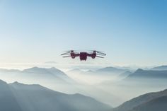 an aerial view of the mountains and sky with two small planes flying in the air