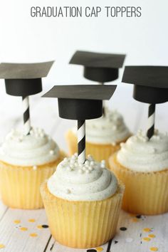 graduation cupcakes with white frosting and black top hats on them are ready to be eaten