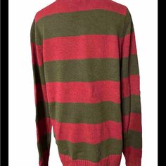 a green and red striped sweater on a mannequin