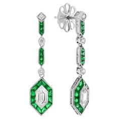 These Art Deco inspired drop earrings features 0.96 carats of total diamonds and 3.75 emerald finished in a dazzling 18k white gold setting. Both glamorous and imaginative, these drop earrings could be the show stopper addition to your jewelry collection! Earrings Information Style: Art Deco Metal: 18K White Gold Width: 8 mm. Length: 36 mm. Weight: 5.80 g. (approx. in total) Backing: Push Back Center Gemstones Type: Diamond Shape: Hexagon Average Color: G Average Clarity: VS Size: 7 x 3.4 mm. Number: 2 Weight: 0.69 Carat (approx. in total) Accent Gemstones Type: Emerald Shape: French Cut Size: 1.9 – 2.6 mm. Number: 38 Weight: 3.75 Carat (approx. in total) Additional Gemstones II Type: Diamond Shape: Round Average Color: H Average Clarity: SI Size: 2 mm. Number: 6 Weight: 0.27 Carat (approx Hexagon Jewelry, Earring Box, Inspiration Art, Large Gift, All Gems, Estilo Art Deco, Fashion Tv, Art Deco Inspired, Art Deco Fashion