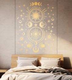 the sun and moon wall sticker is in front of a bed with white sheets