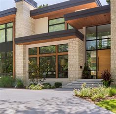 a large house with lots of windows and plants