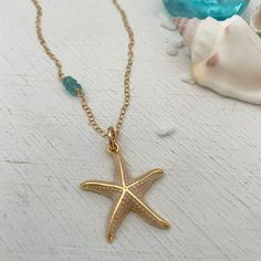 Calling all ocean lovers! This gorgeous golden starfish is perfect for you. Set off your summer tan with a gorgeous enamel accented starfish charm accented beautifully with 3 blue topaz stones. Starfish charm measures approximately 1 inch in diameter. 14kt gold fill chain accented with genuine blue topaz stones. Gold Starfish Charm Jewelry, Ocean-inspired Jewelry With Star Charm, Ocean-inspired Star Charm Jewelry, Ocean-inspired Starfish Jewelry In Ocean Color, Ocean-inspired Starfish Jewelry, Nickel Free Starfish Jewelry In Ocean-inspired Style, Nickel-free Starfish Jewelry With Ocean-inspired Style, Gold Nautical Jewelry With Star Charm, Ocean-inspired Gold Jewelry With Star Charm