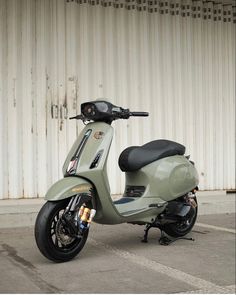 a green scooter parked in front of a building