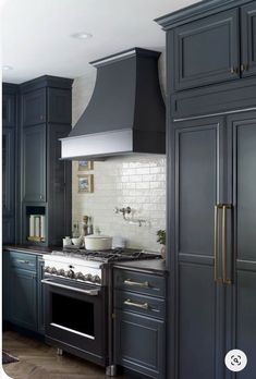 a kitchen with gray cabinets and an oven