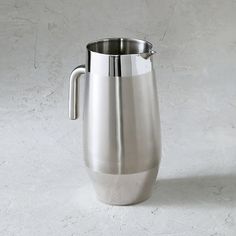 a stainless steel pitcher on a white background