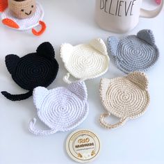 crocheted coasters are sitting next to a coffee cup