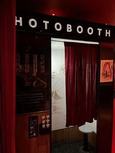 a red curtain is open in front of a photo booth