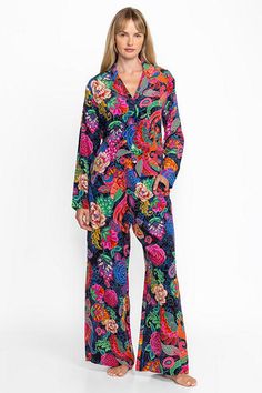 Crafted from 100% luxurious silk, the Jaclyn Long Set Pajamas are adorned with vibrant floral color. Featuring a button-down long sleeve top and wide-leg pants with an easy elastic waist, these sumptuous pajamas are finished with pockets at the side seams. Pair with the Cozy Robe and coordinating slippers for a relaxing night in. Johnny Was Women's Jaclyn Long Pajama Set in Emberwing Pink, Size XS, Silk, Floral Silk Floral Print Long Sleeve Sets, Multicolor Floral Print Silk Set, Silk Multicolor Floral Print Set, Multicolor Floral Silk Set, Multicolor Silk Set With Floral Print, Luxury Silk Long Sleeve Sets, Luxury Long Sleeve Silk Set, Elegant Multicolor Floral Print Sets, Multicolor Long Sleeve Silk Sets