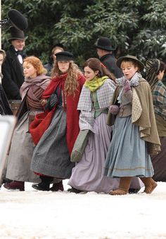 several people dressed in period clothing walking together